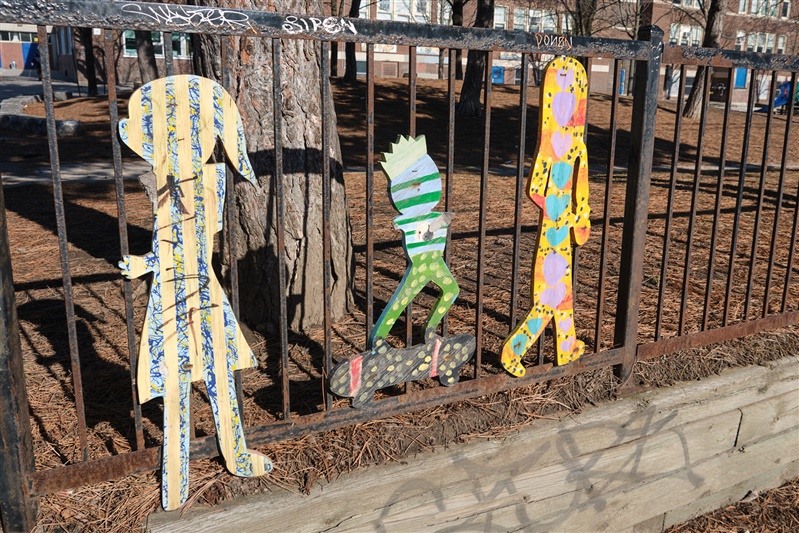 Student artwork lining the schoolyard fence